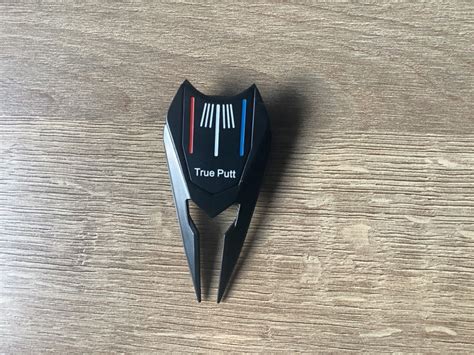 divot repair tool with clip.